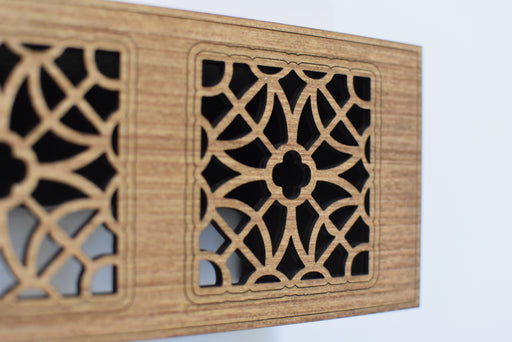 Wooden panel with geometric cut-out design on a white background
