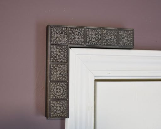 Decorative corbel with intricate design on a plain wall